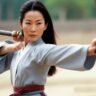 Famous Chinese martial artist girl Michelle Yeoh during practice with sword