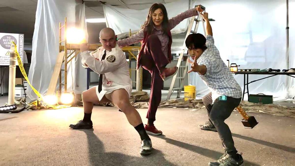 Chinese martial artist girl Michelle Yeoh during action pose with two partner